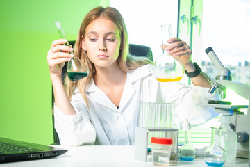 Poster - chemical experiments. girl with flasks in her hands. young woman in a chemical laboratory. flasks wi