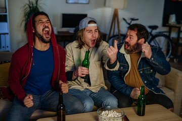 Wall Mural - Happy football fans friends watching football at home and celebrating