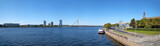 Fototapeta Big Ben - Panoramic view of the Baltic Capital of Riga Latvia. Embankment, view of the riverside with tourist ship and modern skyscrapers. Sunny day in Summer.