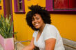 © PICHA - Portrait of a smiling woman sitting on a bench