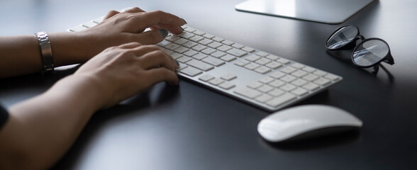 Close up view businesswoman hands typing on keyboard..