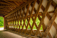 View Of A Covered Bridge's Timber Frame Construction On A Cloudy Day
