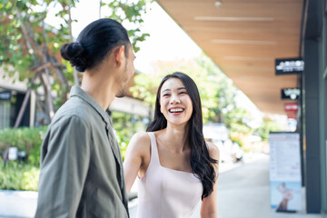 Wall Mural - Asian young man and woman shopping goods outdoors in department store.	