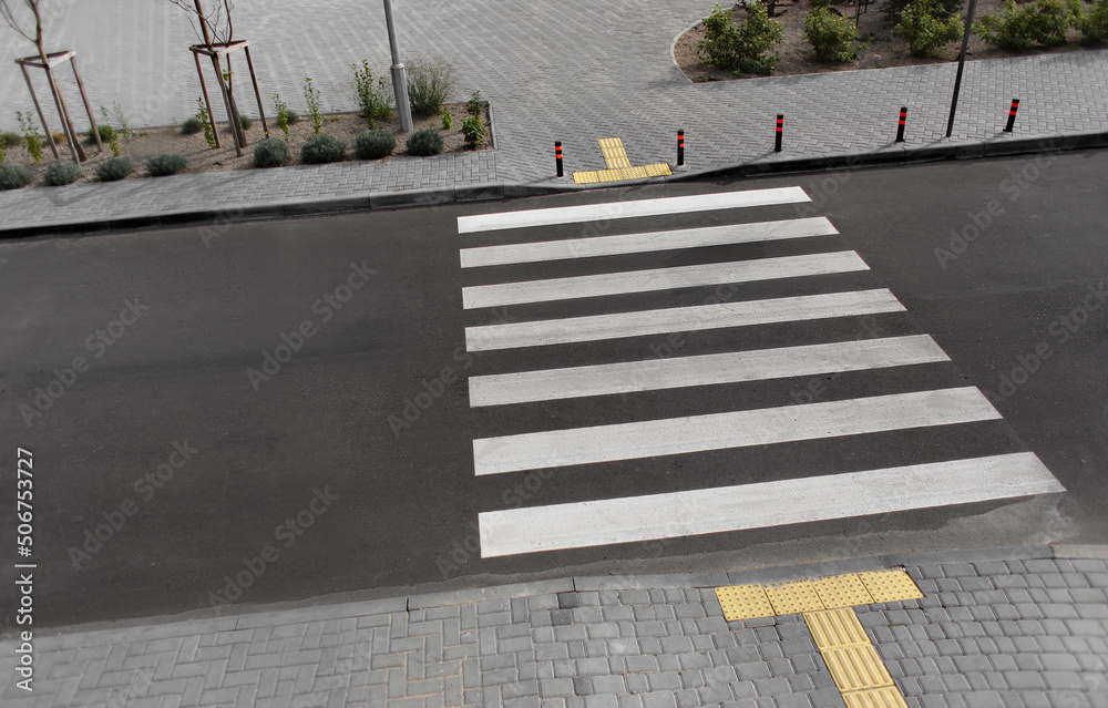 Pedestrian crossing sign on new road in city