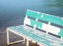 Old Wooden Benches Placed Along The Pier For Relaxation.