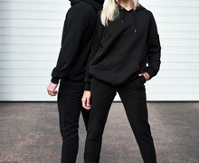 Young Bearded Man And Blonde Girl Is Standing In Plain Hoodie For Logo Printing. Clothing Mockup For Hoodie. Autumn Youngsters Streetwear