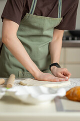 Wall Mural - View of the chef's hands in the process of cooking. Copy space, vertical