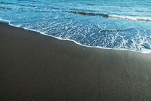 Ocean Foam Covering Wonderful Black Sand Beach Of Tenerife Island.