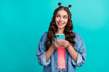 Wall Mural - Photo of young lovely lady wonder look empty space comment blogging use mobile isolated over turquoise color background