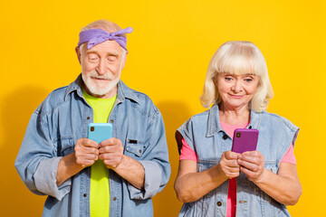 Canvas Print - Photo of busy retired husband wife wear jeans clothes typing modern devices isolated yellow color background