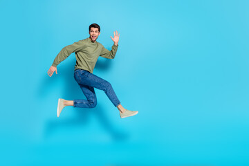 Poster - Full body photo of satisfied glad young person enjoy running jump isolated on blue color background