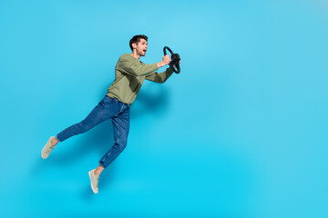 Sticker - Full length photo of overjoyed glad person hold wheel look empty space isolated on blue color background