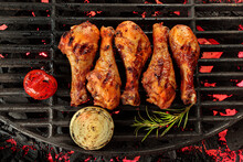 Grilled Chicken Drums On Barbeque Grill With Vegetables And Herbs, Top View