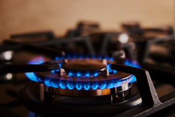 Wall Mural - Close up of blue flame on gas stove burner