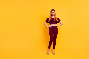 Wall Mural - Full size photo of adorable nice lady put hands waist stand posing isolated on yellow color background