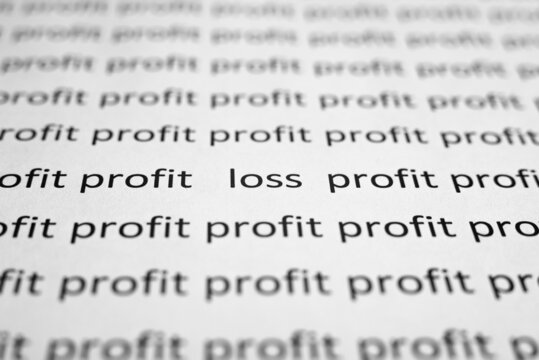 Financial problems, economic crisis concept. Printed text profit and loss on white paper close-up. Selective focus on word Loss, low angle view, macro photo