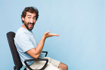 Wall Mural - young adult hispanic crazy man sitting on a chair. copy space concept