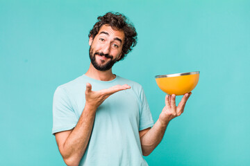 Wall Mural - young adult hispanic crazy man holding an empty bowl