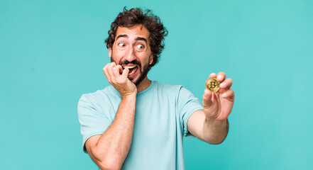 Wall Mural - young adult hispanic crazy man with a bitcoin coin