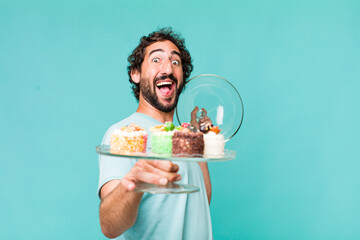 Wall Mural - young adult hispanic crazy man with home made cakes