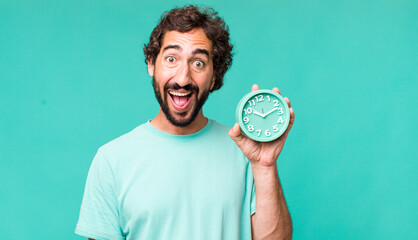 Wall Mural - young adult hispanic crazy man with an alarm clock