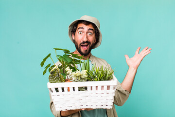 Wall Mural - young adult hispanic crazy man with plants. gardering concept