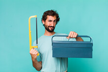Young Adult Hispanic Crazy Man With A Toolbox. Handyman Concept