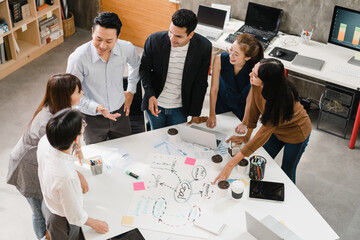 Wall Mural - Multiracial group of young creative people in smart casual wear discussing business brainstorming meeting ideas mobile application software design project in modern office. Coworker teamwork concept.