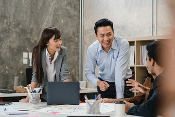 Multiracial group of young creative people in smart casual wear discussing business brainstorming meeting ideas mobile application software design project in modern office. Coworker teamwork concept.