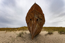 Boats Cemetery Around The Aral Sea. Rusty Carcasses In The Desert Dunes Where Once There Was Water.