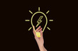 © valiantsin - Hand holding glowing light bulb. New idea, breakthrough, inspiration, finding solution from difficult situation concept on black background. High quality photo