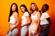 © iordani - diverse multi nation girls group, teenage friends company cheerful having fun, happy smiling, cute posing on yellow background, lifestyle people concept, african-american, asian and caucasian