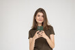 © dianagrytsku - Portrait of a young businesswoman using mobile phone isolated over white background