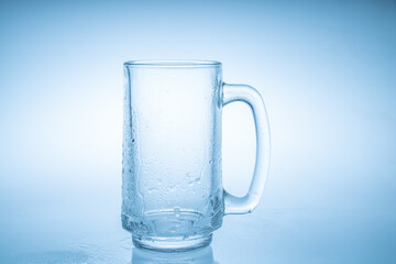 Wall Mural - Empty beer mug with water droplets  isolated on white background
