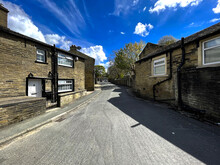 View Along, Green End, With Stone Cottages, Trees And A Blue Sky In The Old Village Of, Clayton, Bradford, UK