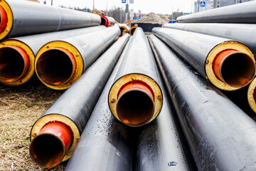 Wall Mural - Insulated pipe. Large metal pipes with a plastic sheath at a construction site. Modern pipeline for supplying hot water and heating to a residential area.