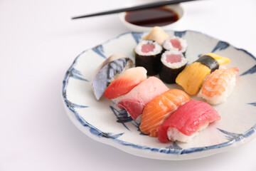 Wall Mural - Sushi Set nigiri and sushi rolls with soy sauce and chopsticks Japanese food isolated in white background