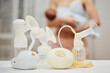 breast pump against the background of a mother holding child.