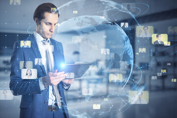 Poster - Global social network and business society concept with young man in suit using digital tablet and virtual screen with world map globe surrounded by people profile pictures icons