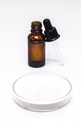 petri dish with mandelic acid, dropper bottle with salicylic acid, with mandelic acid at the bottom. Products to control face oil and antimicrobials