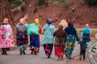 group of berber women going to work on a paved road, Ait Blal, azilal province, Atlas mountain range, morocco, africa