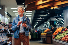 Mature Man Checking Shopping List On His Cellphone