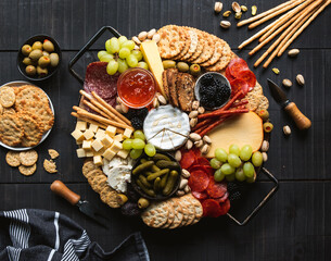 Wall Mural - Overhead of charcuterie board of cheese, meat, crackers and fruit.