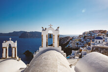 The White Church Bell Tower On Santorini Island In Greece, Oia Village During Sunset.
