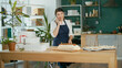 © alex_marina - A Successful Businesswoman Managing Her Business Works in a Cozy Kitchen With a Modern Interior, Using a Computer and a Mobile Phone. Confectioner, Small Business Owner. Startup.