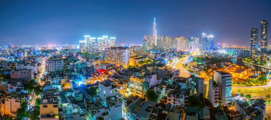 Aerial view of Bitexco Tower, buildings, roads, Thu Thiem 2 bridge and Saigon river in Ho Chi Minh city - Far away is Landmark 81 skyscraper. Travel concept.