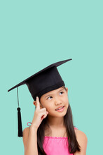 Happy Asian School Girl With Copy Space. Student Child Graduate In Graduation Cap.