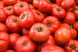 Tomatoes stacked on top of each other in a supermarket for sale, tomato texture.