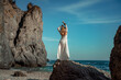 © svetograph - Middle aged woman looks good with blond hair, boho style in white long dress on the beach decorations on her neck and arms.