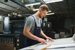 © Serhii - Man working in printing house with paper and paints